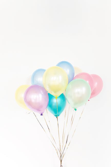 A vibrant cluster of pastel balloons with white background, ideal for celebrations.